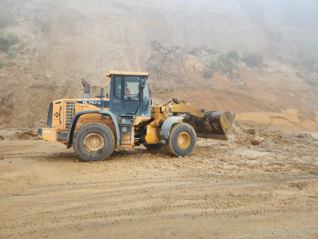 Construction vehicle working in the fog